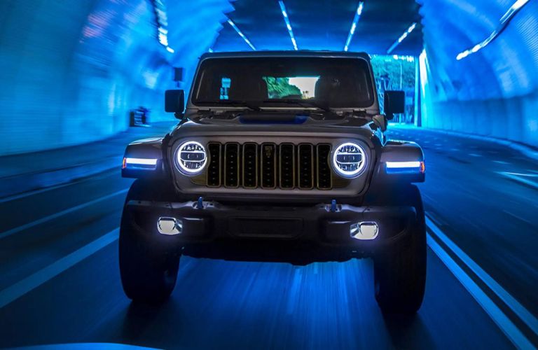 One grey color 2024 Jeep Wrangler is running on the road.